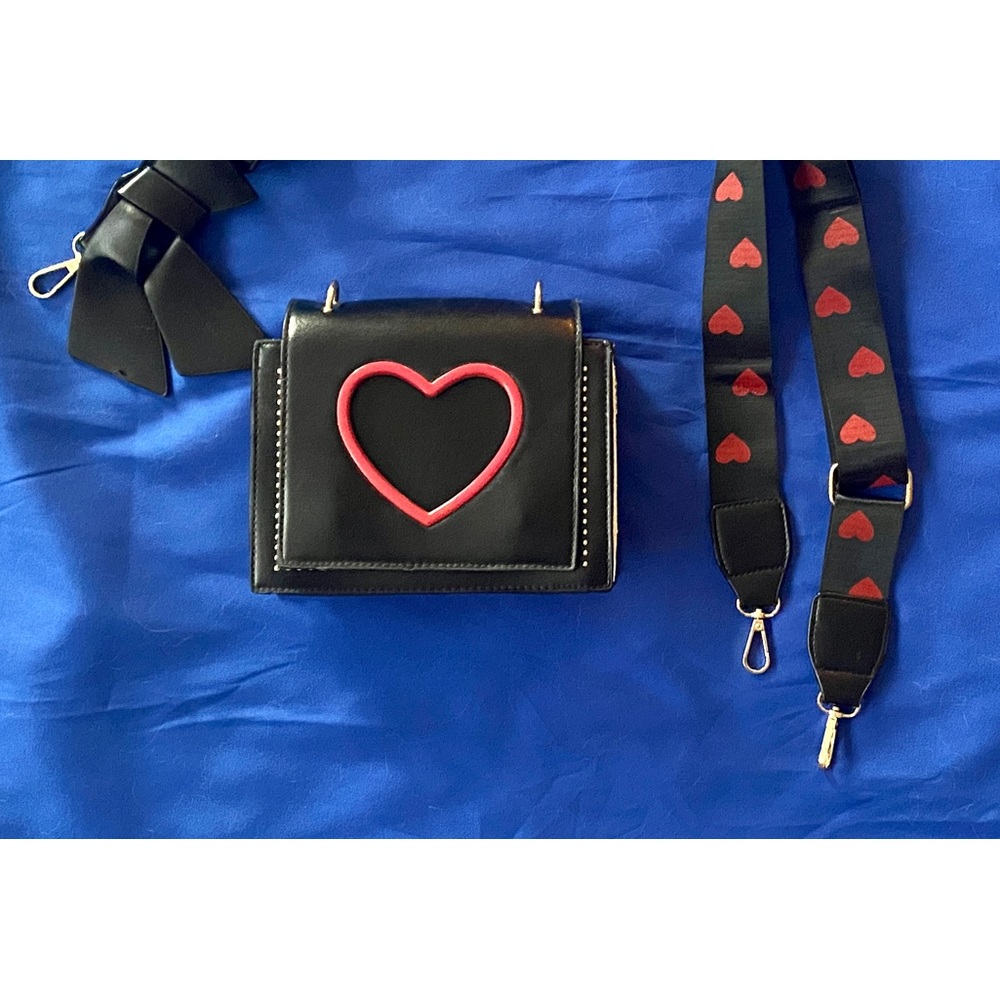 Black crossbody bag with cut out red heart